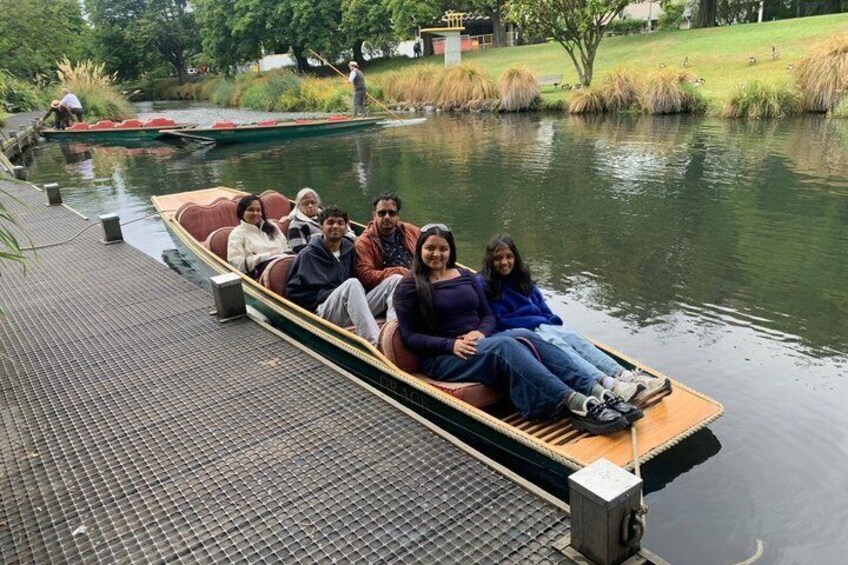 Eine Gruppe von Menschen in einem schmalen Boot auf einem ruhigen Fluss. 4