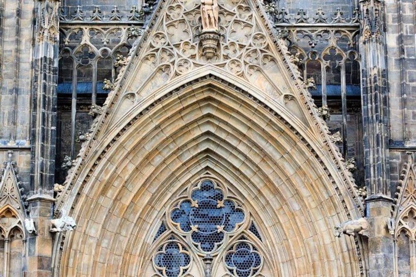 A Gothic cathedral facade with pointed arches, intricate stone carvings, and stained glass windows. 2