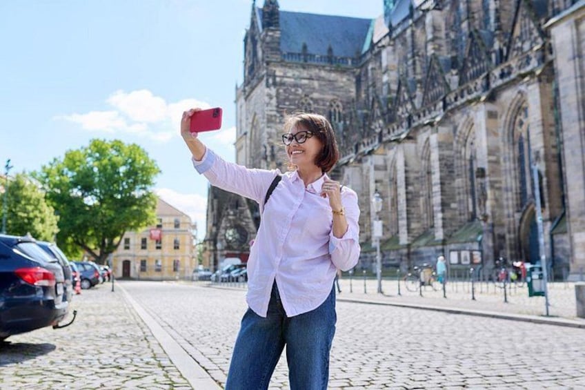 A person taking a selfie with a historic building in the background. 5