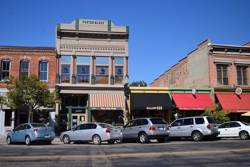 A street with parked cars, a building labeled 'Porter Block,' and storefronts including 'Gallery 23' and 'The City Club.' 3