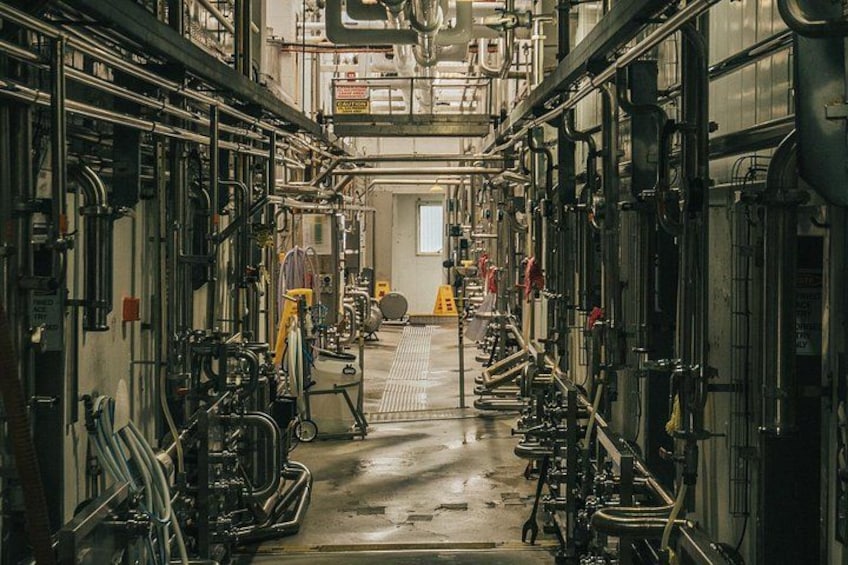 An industrial setting with pipes, valves, and machinery. 5