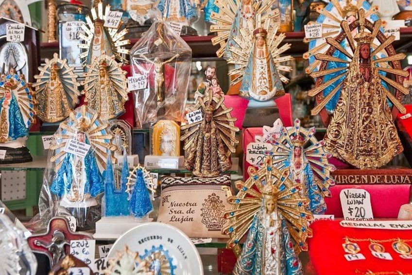 A variety of religious statues and figures, some with price tags. 5