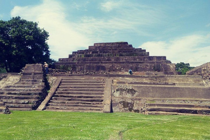 Ancient stone steps leading up to a pyramid-like structure. 4