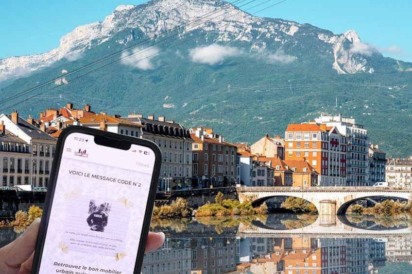 A smartphone displaying a message with a mountain and buildings in the background. 3