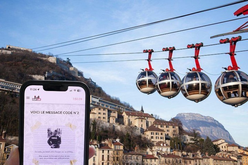 A smartphone displaying a message with a scenic background of a town with historic buildings and a cable car system. 5