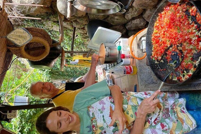 A person cooking with a frying pan on a stove, surrounded by cooking utensils and ingredients. 3