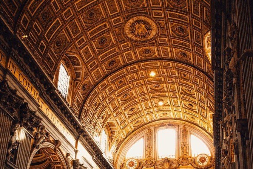 A grand interior with a highly decorated ceiling, intricate patterns, and classical architecture. 4