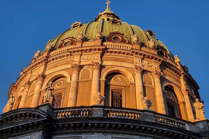A grand building with a large dome and ornate columns. 2