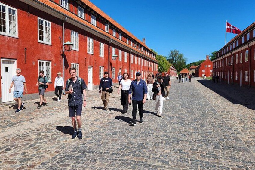 Walking through the historic red barracks of Kastellet fortress – a hidden gem on our Copenhagen Highlights tour. 2