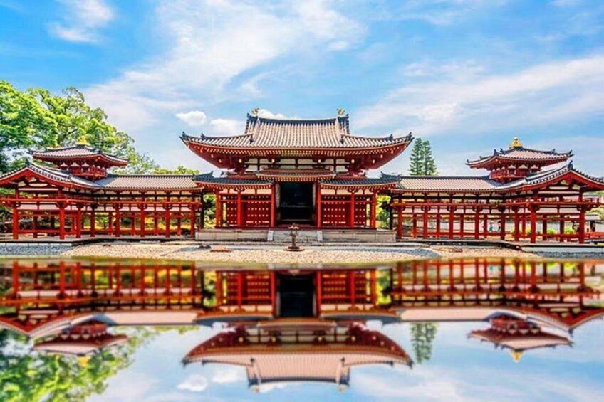 A traditional East Asian temple with red wooden structures and a reflective pond. 3