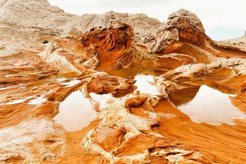 A geological landscape with layered rock formations and reflective pools. 1