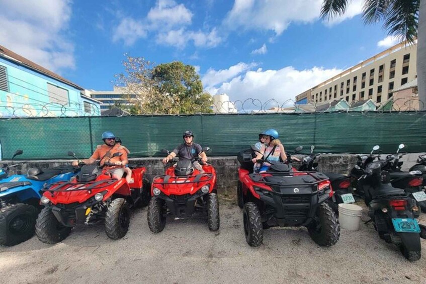 Three people on quad bikes parked in a line. 4