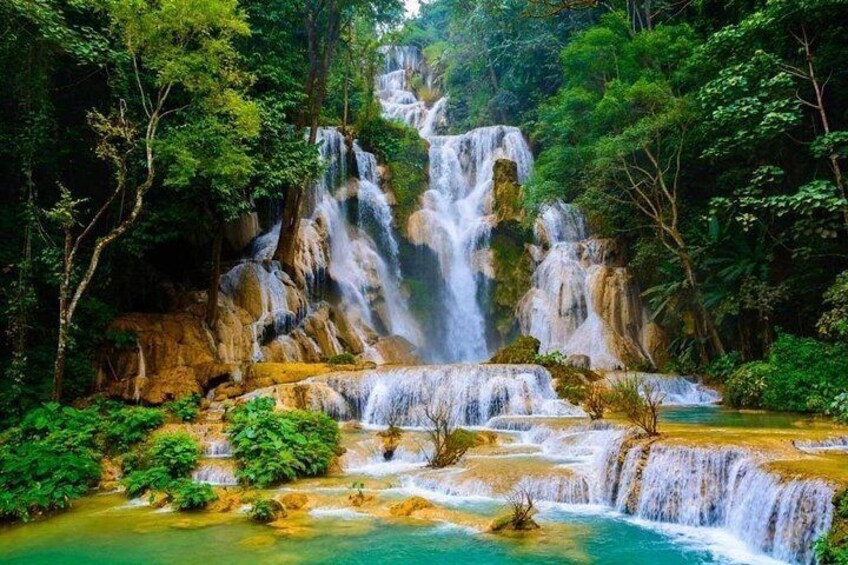 A multi-tiered waterfall surrounded by lush greenery. 3