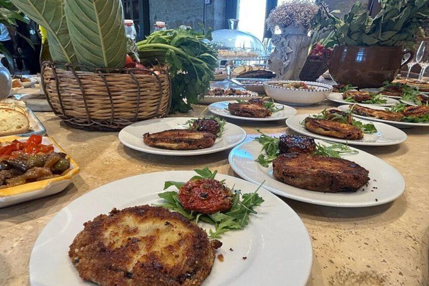 A table with various dishes, including grilled meat and salads. 3