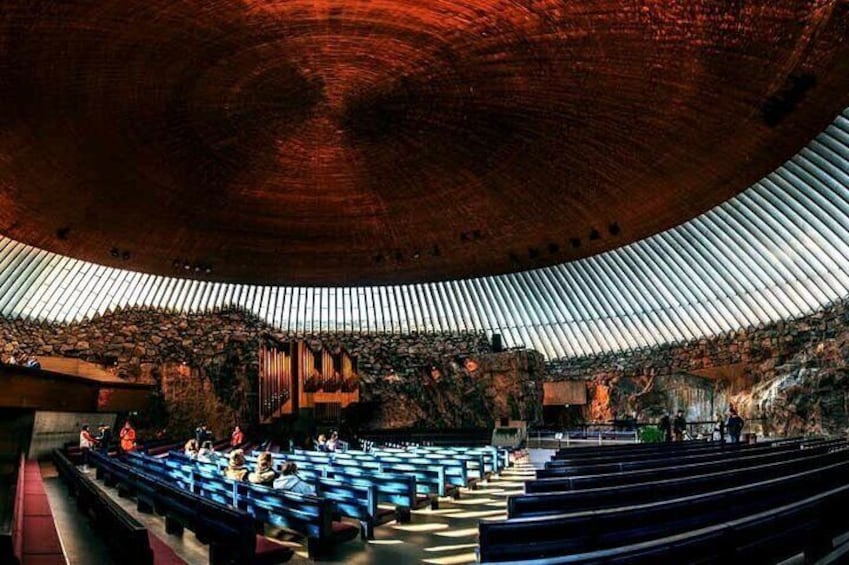 An indoor amphitheater with tiered seating and a large, curved ceiling. 5