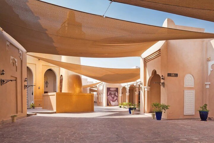 A courtyard with arches, a central fountain, and potted plants. 2
