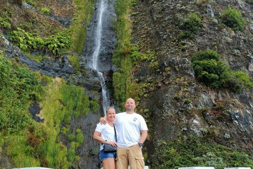 A waterfall cascading down a rocky cliff with lush greenery. 5