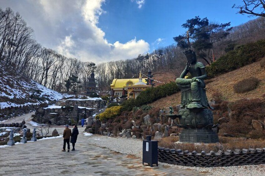 A statue, a building, and a path. 2