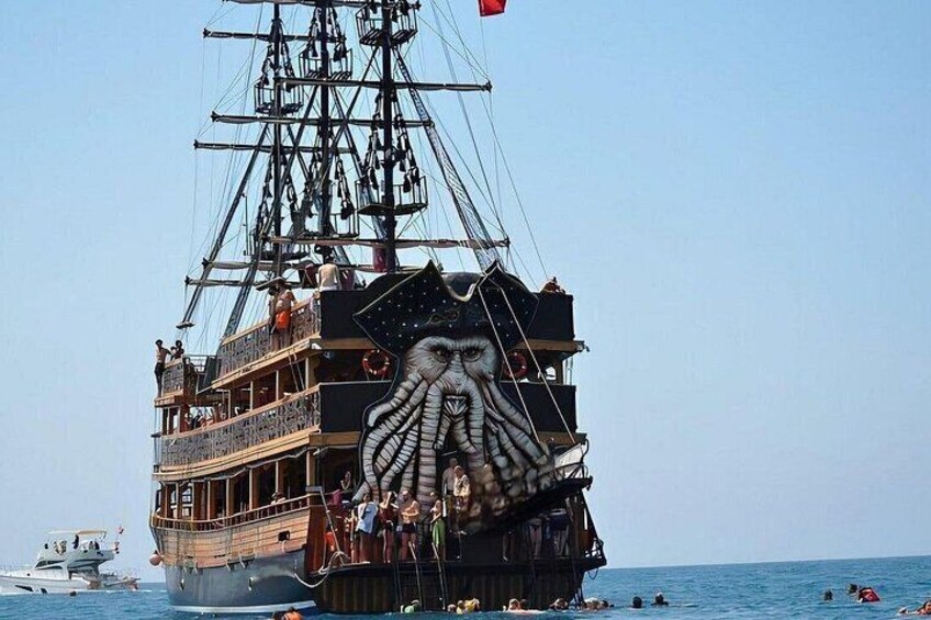 A large ship with a prominent octopus design on its bow, sailing on the water. 2