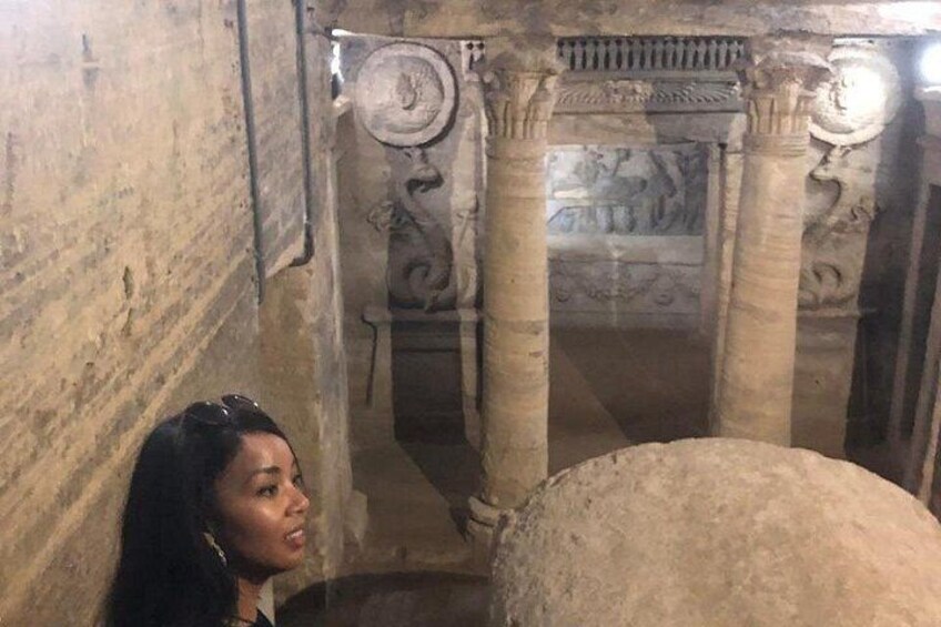 An interior of a historical building with columns and a large stone structure. 5