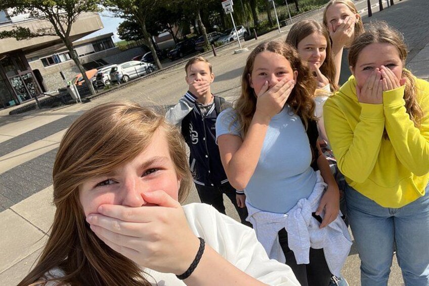 A group of people standing on a sidewalk. 2
