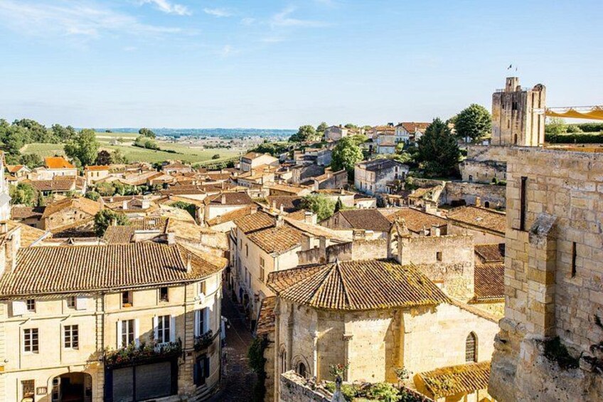 A historic town with medieval architecture, cobblestone streets, and a prominent church tower. 4