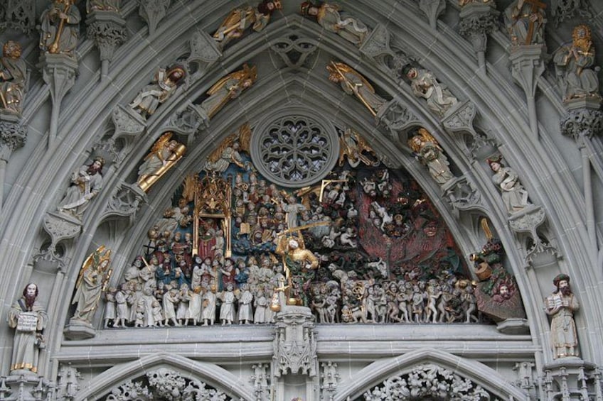 A detailed Gothic cathedral facade with statues, intricate carvings, and a large stained glass window. 3