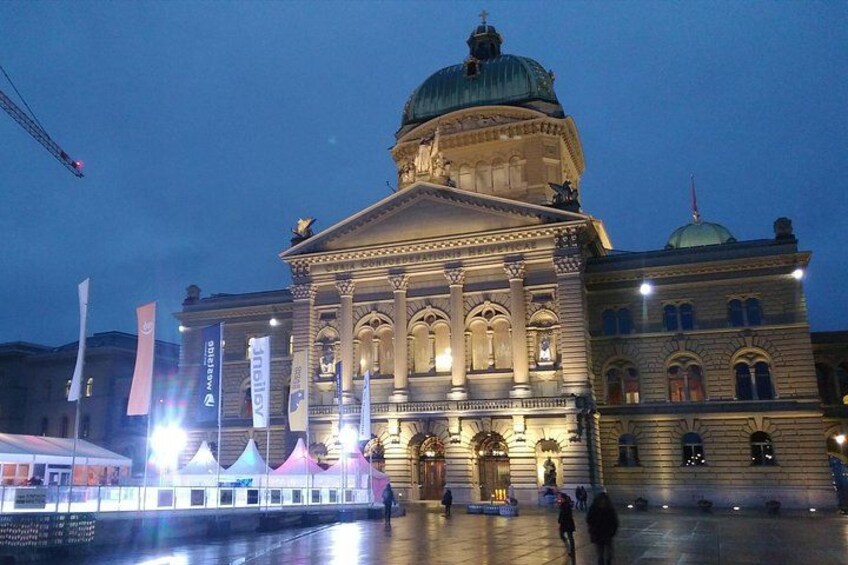A historic building with a dome and columns, illuminated at night. 1
