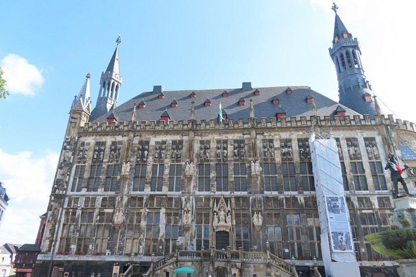 A historic building with intricate stonework and two prominent towers. 4