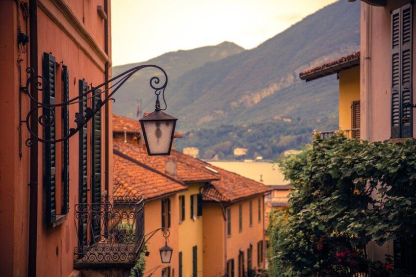 A street with buildings, a street lamp, and mountains in the background. 4