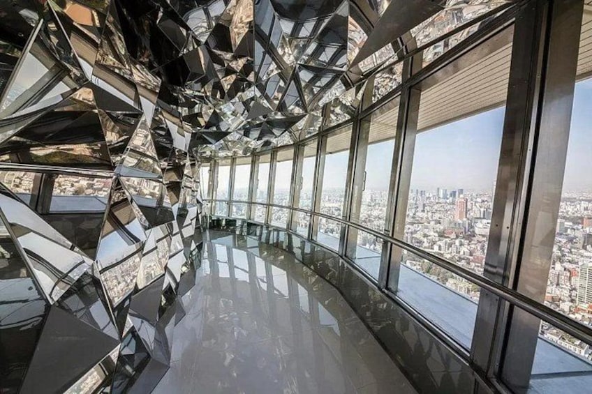 A modern architectural interior with reflective surfaces and large windows. 4