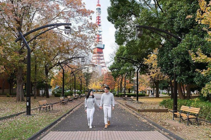 A park pathway lined with trees and benches, with a tower in the background. 5