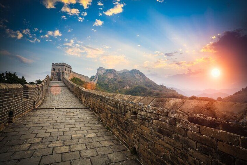 The Great Wall of China with a sunset in the background. 1