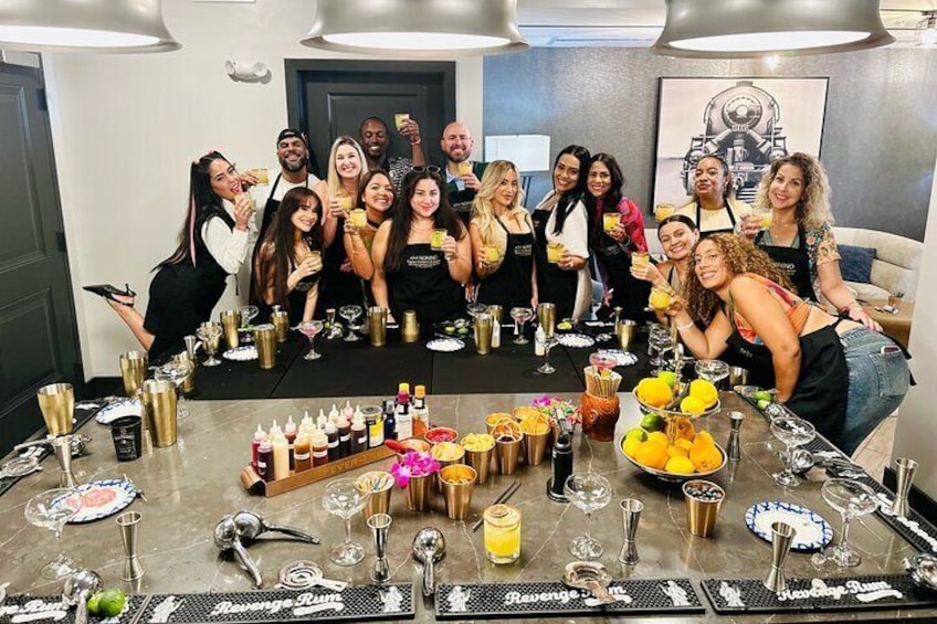 A group of people at a bar with drinks and bottles. 5