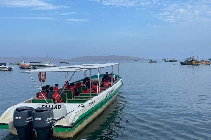 A boat named 'CATTALO' on calm water with other boats in the background. 2