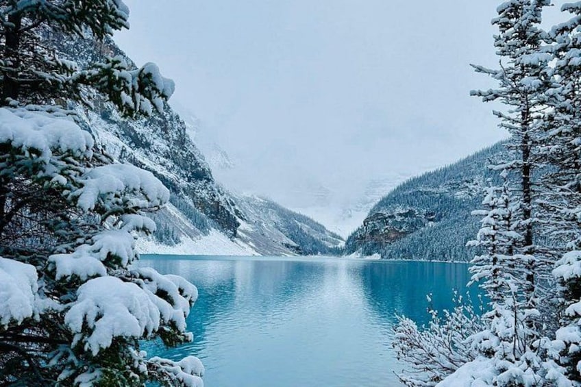 A snow-covered lake surrounded by mountains. 2