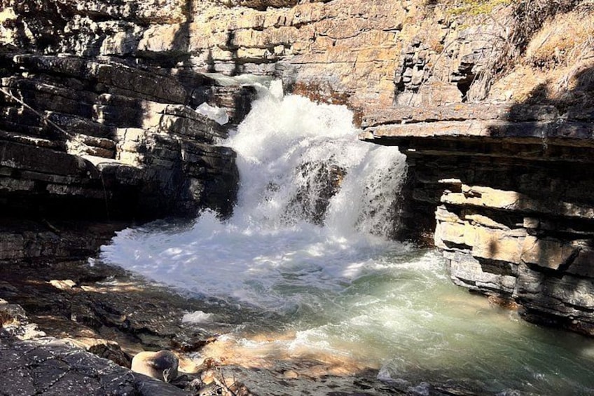 A waterfall cascading over rocky terrain. 3