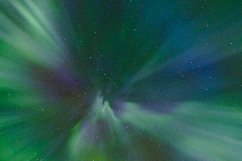 A starry night sky with visible constellations and a greenish aurora. 2