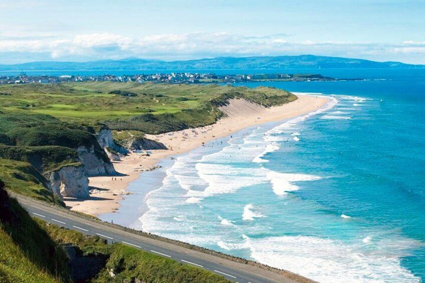A coastal road with cliffs and a beach. 5