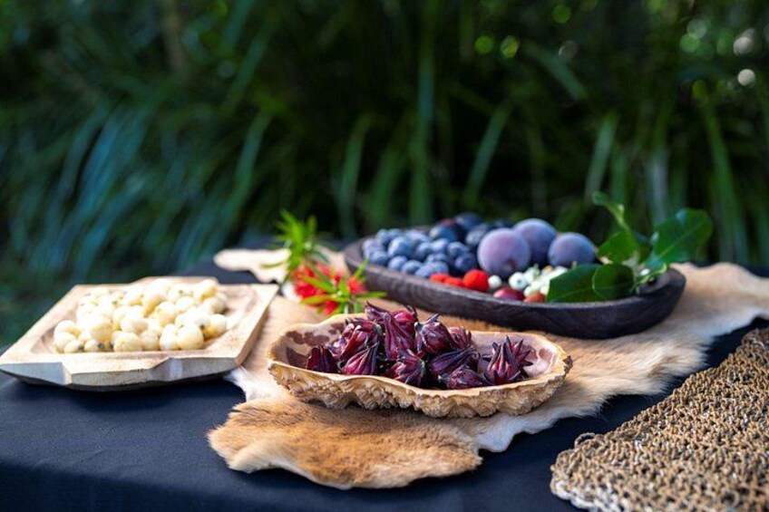 A table with various fruits and nuts on a cloth. 1