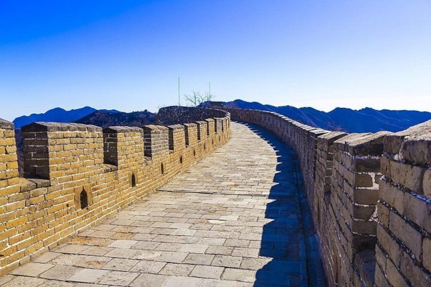 A section of the Great Wall of China with stone bricks and a clear sky. 2