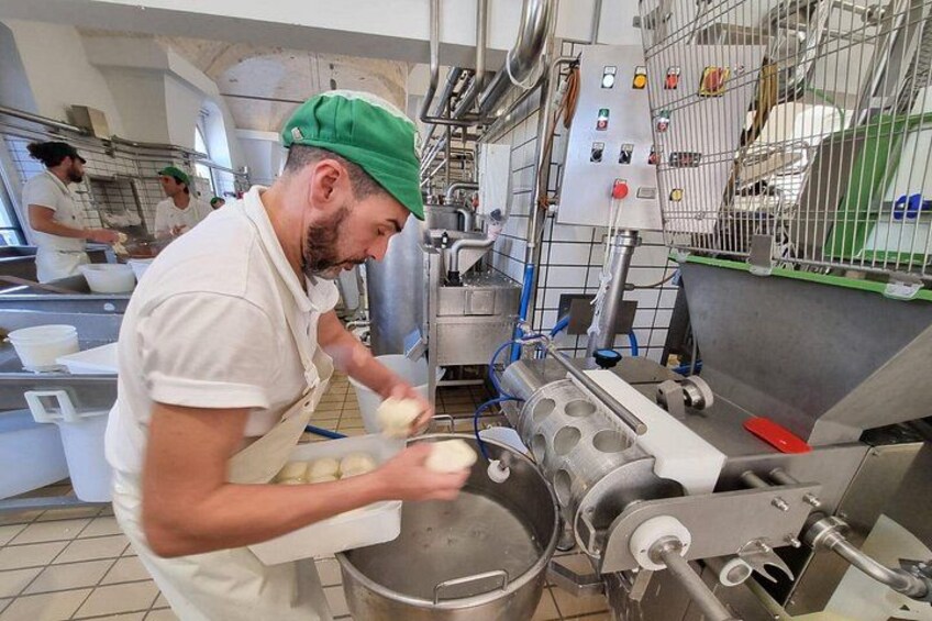 A chef preparing food in a professional kitchen with stainless steel equipment and a focus on food preparation. 4