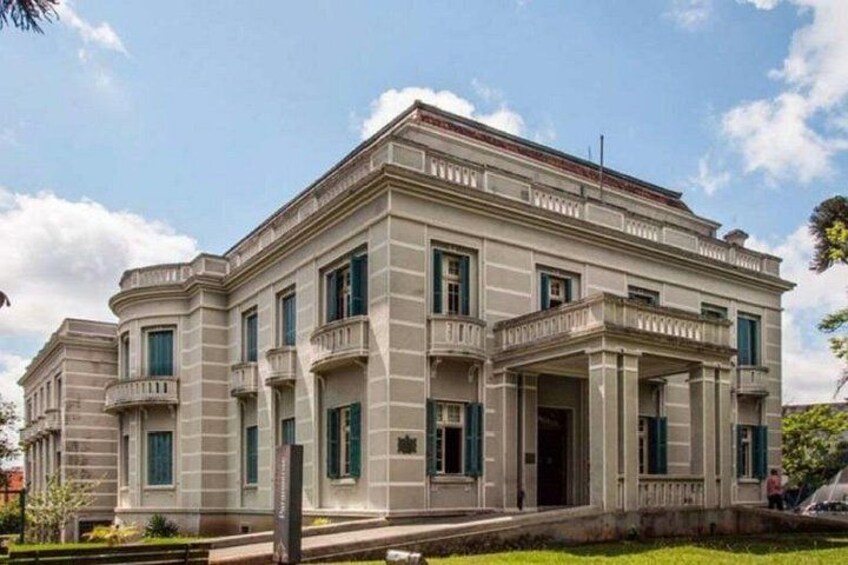 A large, classical building with a symmetrical facade, columns, and a central entrance. 2