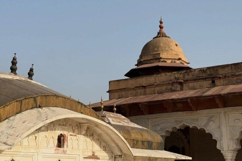 A historical building with domed roofs and arched gateways. 4