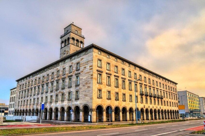 A large, historic building with multiple arches and a prominent tower. 2