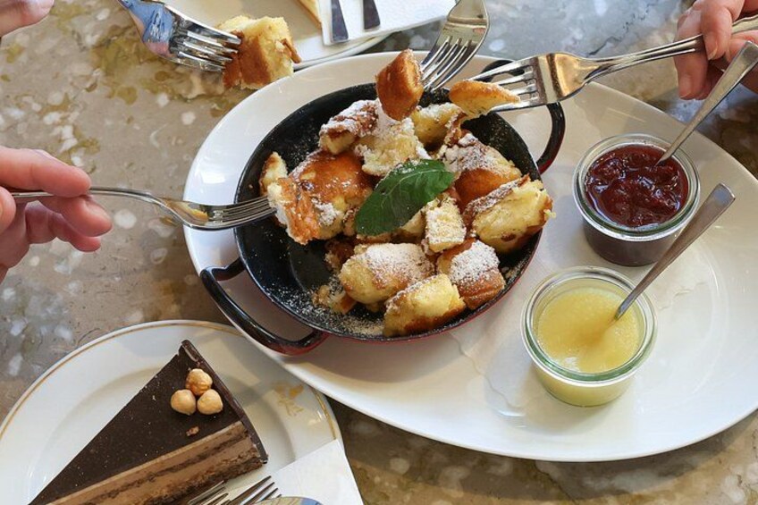 A plate with a dessert, a bowl of bread, and two small containers of jam and butter. 4