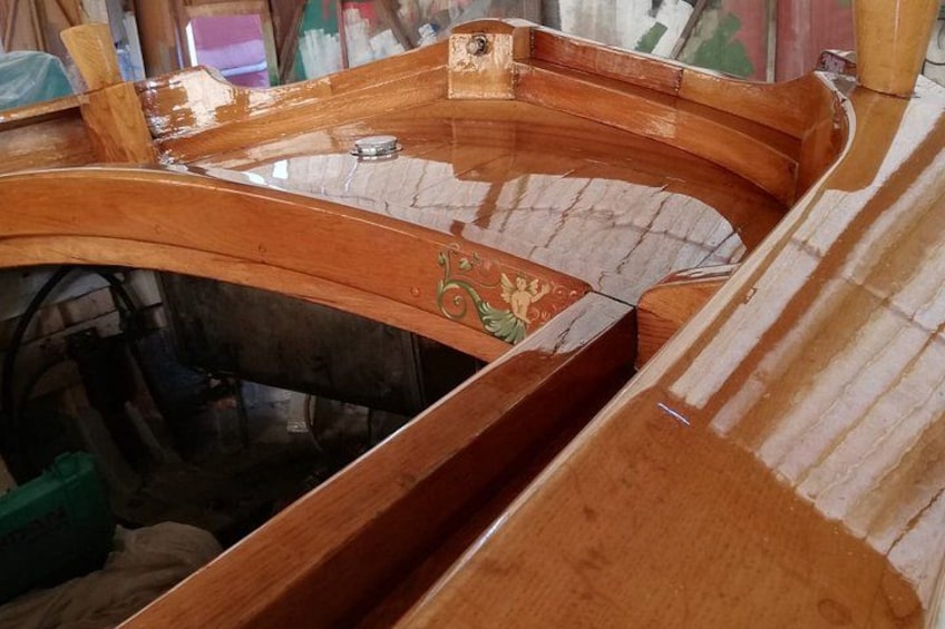 A wooden boat under construction with visible craftsmanship details. 3