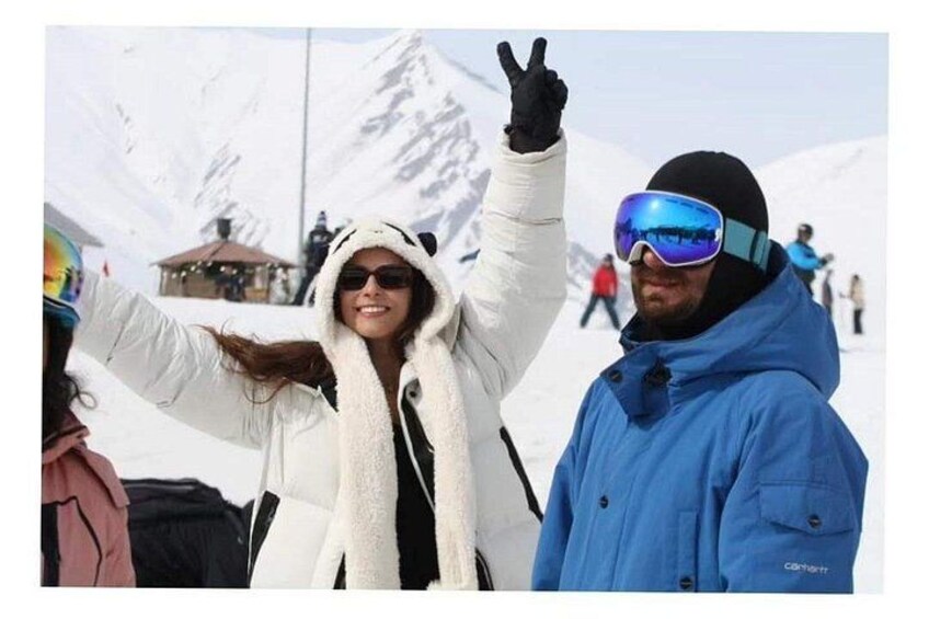 Un paysage de montagne enneigé où l’on voit des personnes faire du ski. 1