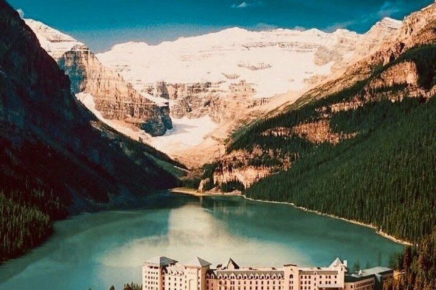 A mountain lake with a building at the base. 2
