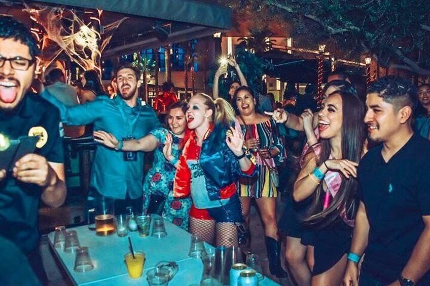 A group of people at a party with drinks on a table. 5